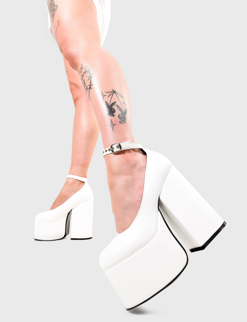 Double Up! Copy My Lingo Platform Heels in White faux leather. These platform heels feature an adjustable white ankle strap with silver eyelets and 'O' ring shaped buckle, rise the standards with these platform heels.Made with eco-friendly materials and 100% cruelty-free, these platform boots are as ethical as they are HOT! - Platform Height - Heel Height - Adjustable white ankle strap - Silver eyelets with 'O' ring shaped buckle - Chunky Platform sole - Round Toe - 100% vegan SKU: LMF 2673 - WhitePU