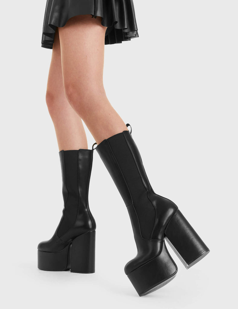 Not Your Basic Boots Intrusion Platform Calf Boots in Black faux leather. These platform boots feature a minimalist design, with a stretchy gusset and a pull tag, perfect with any outfit. Made with eco-friendly materials and 100% cruelty-free, these platform boots are as ethical as they are Perfect! - Platform Height - Heel Height - gusset and pull tag - calf length - Platform sole - High Heel - 100% vegan SKU: LMF 2850 - BlackPU
