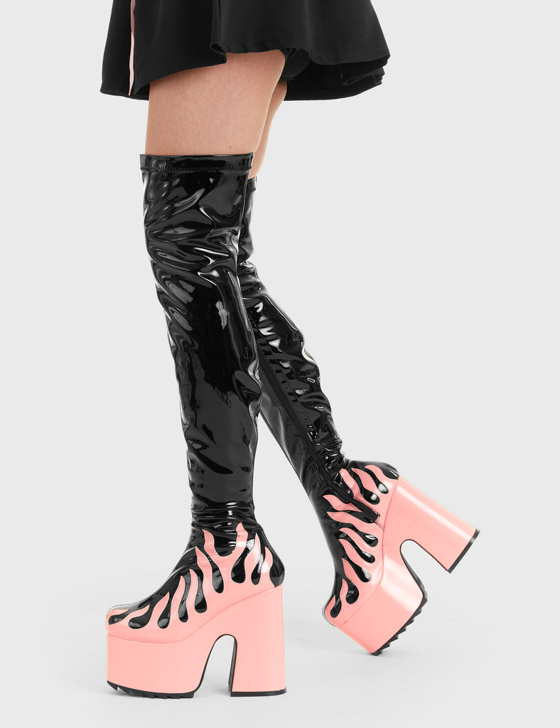 Bring The Heat Light Up Platform Thigh High Boots in Black Patent. These platform boots feature a Pink Patent flame as well as a Pink Patent Platform, elevate your fashion game. Made with eco-friendly materials and 100% cruelty-free, these platform boots are as ethical as they are Hot. - Platform Height - Heel Height - Black Zip - Pink Patent Flame - Chunky Platform sole - Shark's teeth grip - 100% vegan SKU: LMF 2937 Black Patent/ Pink Flame