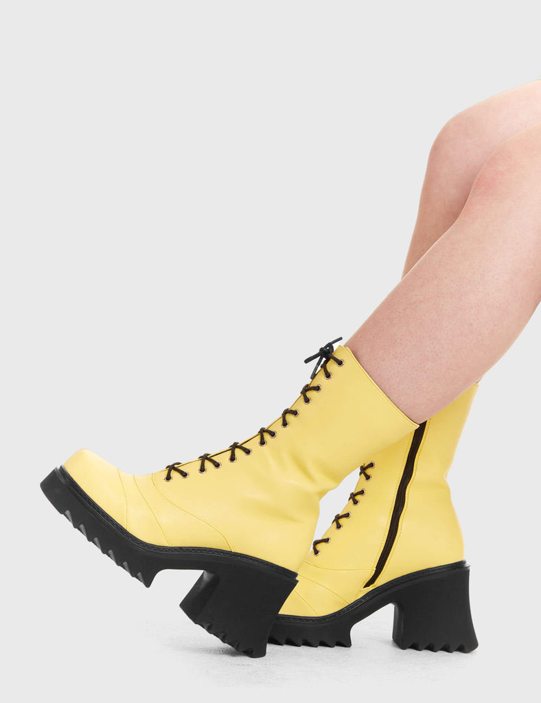 LACED UP On A Buzz Chunky Platform Ankle Boots in yellow faux leather. These vegan western Boots feature black laces and a shark teeth grip sole, very chic. Made with eco-friendly materials and 100% cruelty-free, these boots are as ethical as they are edgy! - Chunky Platform - Calf length - Shark teeth grip - Black laces - Rounded toe - 100% vegan SKU: LMF 3730 - LemonPU