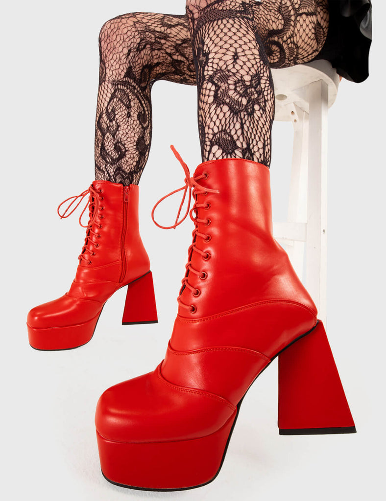 KEEP IT SMOOTH Strollin' Platform Ankle Boots in Red faux leather. These platform boots feature a minimalist look with a triangle heel, keeping it nice and classy. Made with eco-friendly materials and 100% cruelty-free, these platform boots are as ethical as they are chic. - Platform Height - Ankle length - Lace up - Triangle heel - High Heel - 100% vegan SKU: LMF 3331 - RedPU