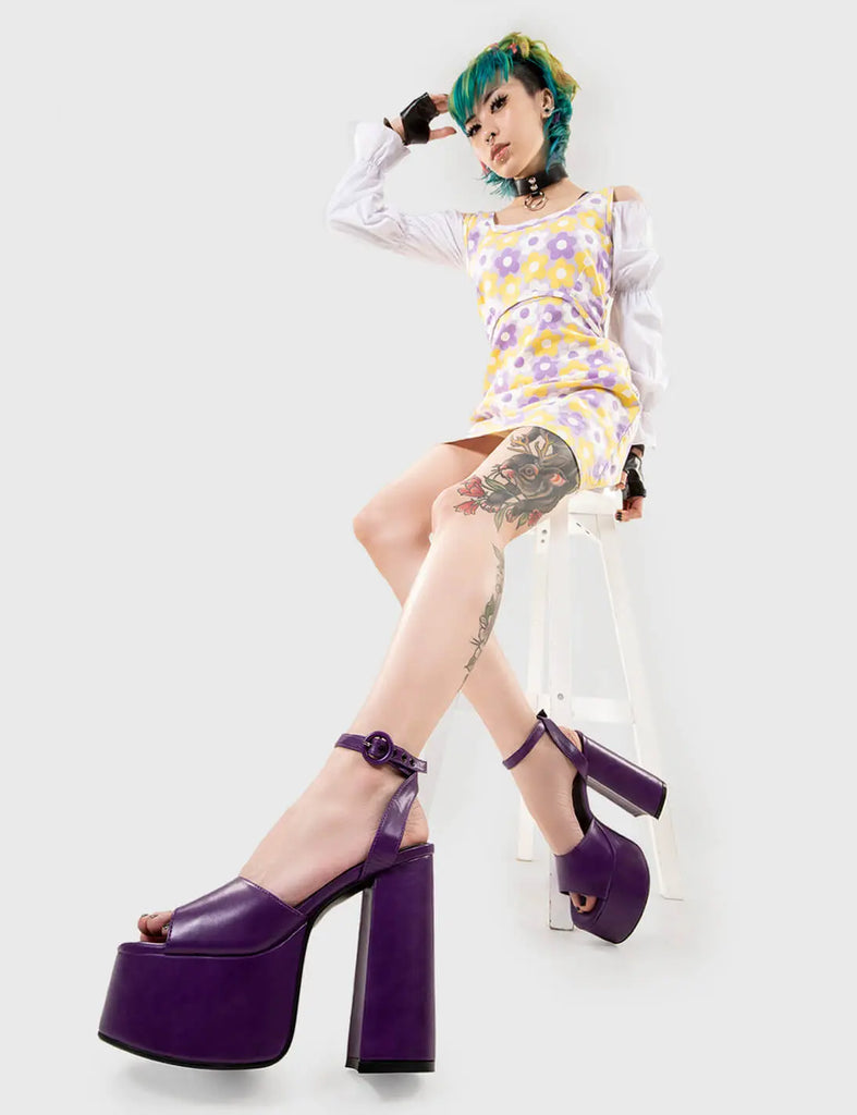 MAKE YOUR STATEMENT All For You Platform Sandals in Purple Pu. These vegan Sandals feature an adjustable ankle strap with a Platform sole and high heel, perfect for adding height and glamour to any outfit. Made with eco-friendly materials and 100% cruelty-free, these Sandals are as ethical as they are hot! - Platform Height: 2.5 inch - Heel Height: 5.5 inch - Open Toe - Wrap around ankle strap - O shaped buckle and silver eyelets - Platform sole - Round toe - 100% vegan SKU: LMS 104 - PurplePU