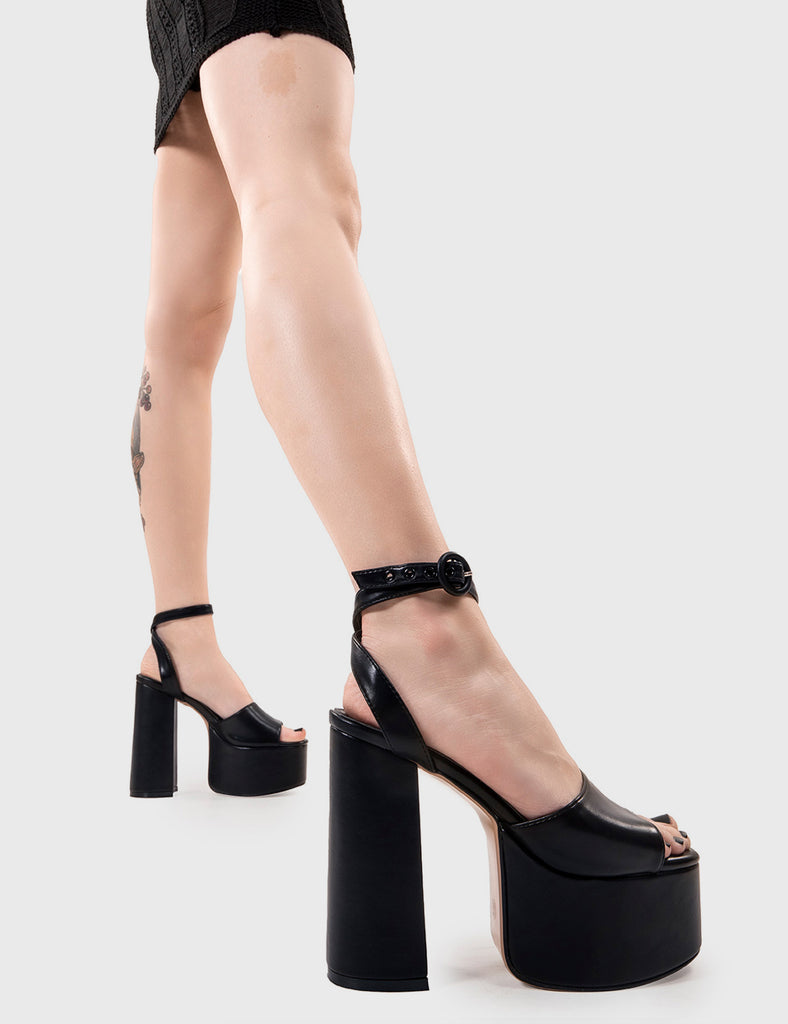 MAKE YOUR STATEMENT All For You Platform Sandals in Black PU. These vegan Sandals feature an adjustable ankle strap with a Platform sole and high heel, perfect for adding height and glamour to any outfit. Made with eco-friendly materials and 100% cruelty-free, these Sandals are as ethical as they are hot! - Platform Height: 2.5 inch - Heel Height: 5.5 inch - Open Toe - Wrap around ankle strap - O shaped buckle and silver eyelets - Platform sole - Round toe - 100% vegan SKU: LMS 104 - BlackPU