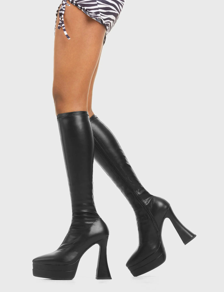 THESE BOOTS ARE MAKE FOR WALKING Alter Ego Platform Knee High Boots in Black fitted faux leather. These platform boots feature a minimalist look with a flared heel. Made with eco-friendly materials and 100% cruelty-free, these platform boots are as ethical as they are chic. - Platform Height - Fitted feel - Flared heel - Pointed toe - High Heel - 100% vegan SKU: LMF 3532 - BlackPUStretch