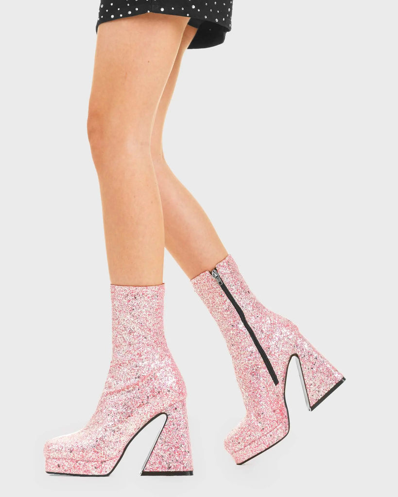 SPARKLE UP YOUR LOOK Another Love Platform Ankle Boots in Pink Glitter. These vegan western Boots feature sparkling pink glitter with a flared heel. Made with eco-friendly materials and 100% cruelty-free, these boots are as ethical as they are Eye-Catching! - Platformed Heel - Calf length - Pink glitter - 100% vegan SKU:LMF 3822 - PinkGlitter