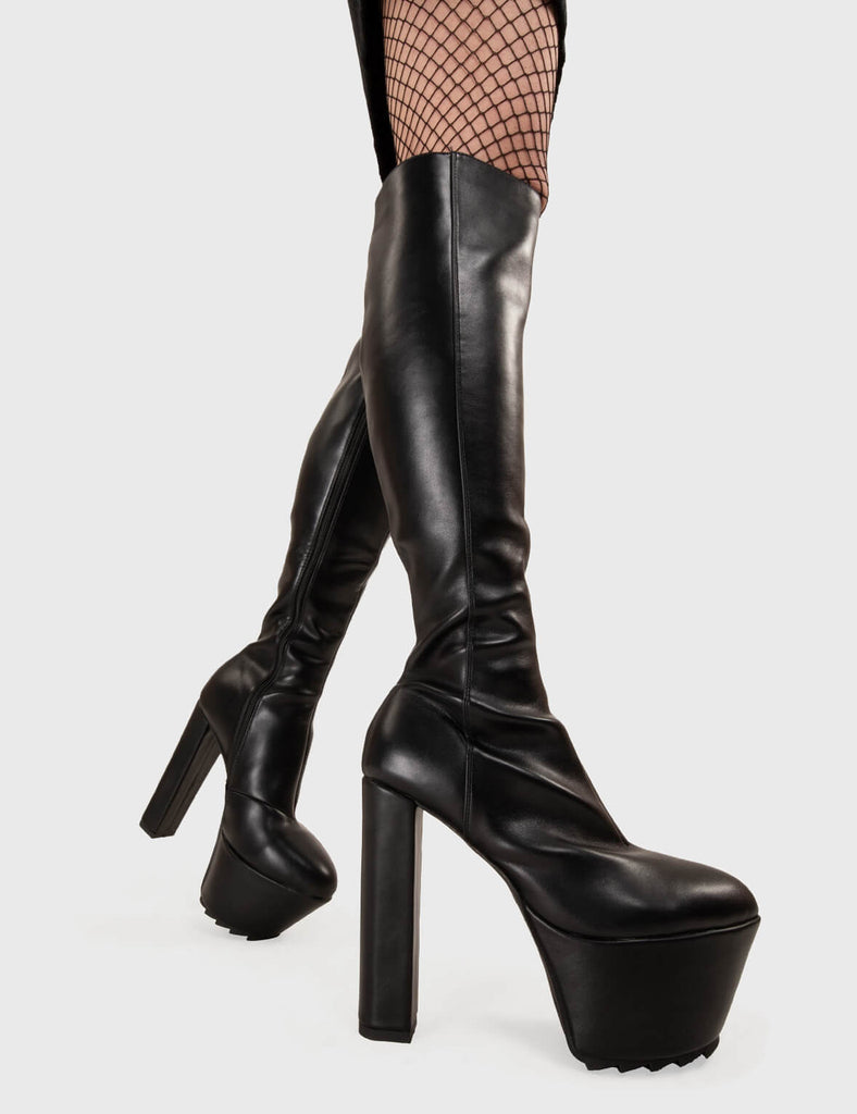 Not Your Basic Boots! Can't Stand You Platform Knee High Boots in Black faux leather. These platform boots feature a minimalist design with a pointed toe, on our platform sole and high heel. Made with eco-friendly materials and 100% cruelty-free, these platform boots are as ethical as they are eye-catching. - Platform Height - Heel Height - Black zip - Pointed toe - High Heel - Platform Sole - Shark's Teeth Grip - 100% vegan SKU: LMF 3116 - BlackPU