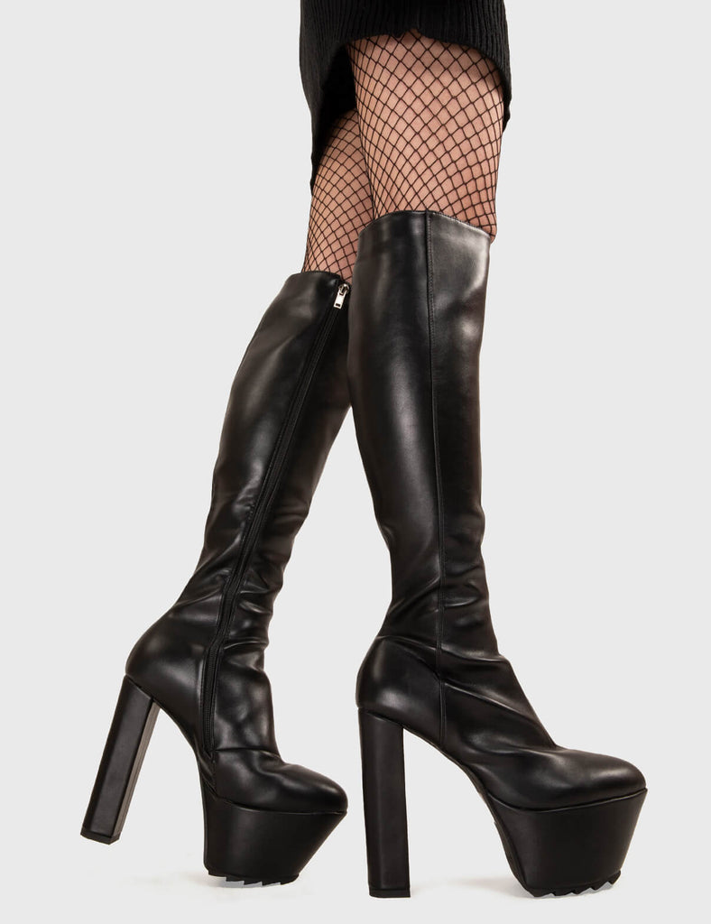 Not Your Basic Boots! Can't Stand You Platform Knee High Boots in Black faux leather. These platform boots feature a minimalist design with a pointed toe, on our platform sole and high heel. Made with eco-friendly materials and 100% cruelty-free, these platform boots are as ethical as they are eye-catching. - Platform Height - Heel Height - Black zip - Pointed toe - High Heel - Platform Sole - Shark's Teeth Grip - 100% vegan SKU: LMF 3116 - BlackPU