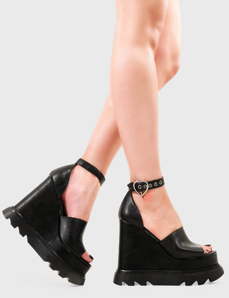 Cheeky Commotion Commotion Chunky Platform Sandals in Black faux leather. These sandals feature an adjustable ankle strap with silver eyelets and heart shaped buckles, infuse the charm and leave a lasting impression. Made with eco-friendly materials and 100% cruelty-free, these platform boots are as ethical as they are Charming. - Platform Height - Heel Height - Adjustable black strap - Silver eyelets with heart shaped buckle - Chunky Platform sole - Round Toe - 100% vegan SKU: LMF 2640 - BlackPU