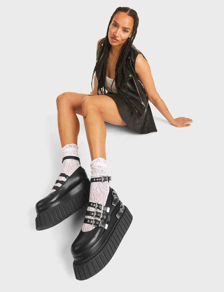 Daydreaming Chunky Platform Creeper Shoes in Black Faux Leather. These creepers feature silver buckles and four adjustable straps, with two decorative straps on the body of the shoe. Made with eco-friendly materials and 100% cruelty-free, these creepers are as ethical as they are edgy! 