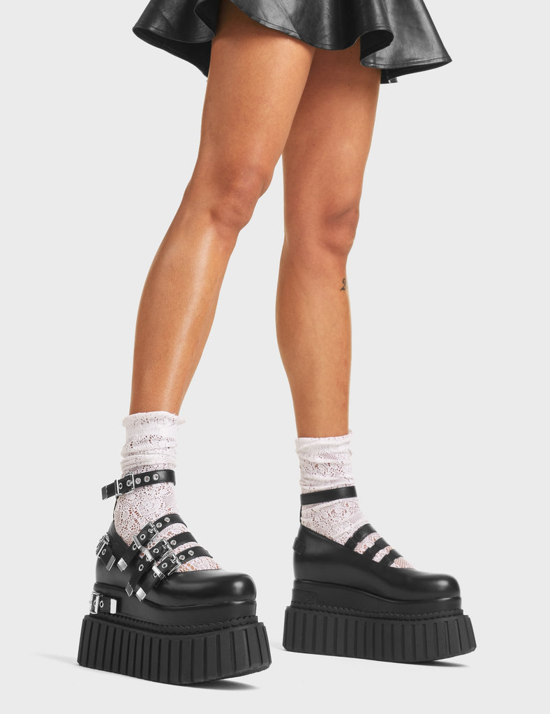 Daydreaming Chunky Platform Creeper Shoes in Black Faux Leather. These creepers feature silver buckles and four adjustable straps, with two decorative straps on the body of the shoe. Made with eco-friendly materials and 100% cruelty-free, these creepers are as ethical as they are edgy! 