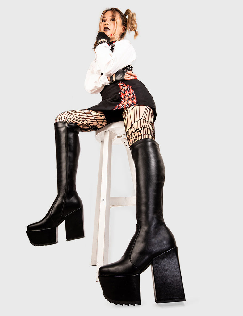 Lift Off Disappearance Platform Knee High Boots in black faux leather. These black vegan Platform Boots feature on our chunky platform sole,take off with confidence andd ignite your style! Made with eco-friendly materials and 100% cruelty-free, these platform boots are as ethical as they are Bootiful! - Platform Height: 2 inch - Heel Height: 4.8 inch - Black zipper - Chunky platform sole - Shark's teeth grip - Round Toe - 100% vegan SKU: LMF 1981 - BlackPU