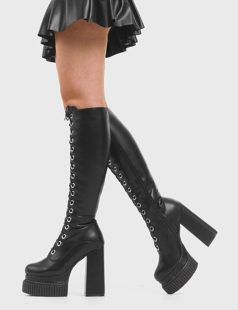 HIGH IN THE SKY Elevators Creeper Platform Knee High Boots in Black faux leather. These vegan western Boots feature a lace up design and Black stitch detailing. Made with eco-friendly materials and 100% cruelty-free, these boots are as ethical as they are trendy! - Heel Height - Knee high length - Black stitching - Black zip - Rubber grip sole - Rounded toe - 100% vegan SKU: LMF 3967 - BlackPU