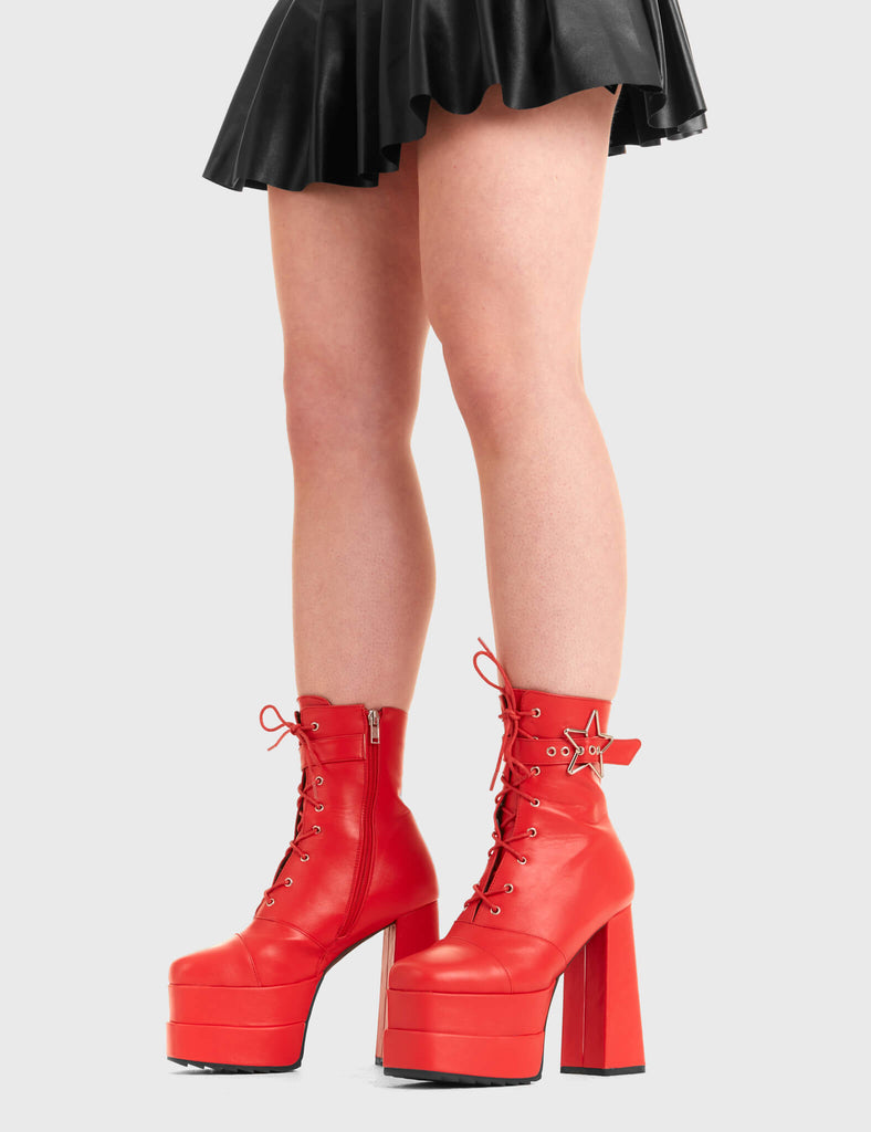 STAR GAZING Famous Friend Platform Ankle Boots in Red faux leather. These platform boots feature a silver star buckle with an adjustable strap, keeping it nice and classy. Made with eco-friendly materials and 100% cruelty-free, these platform boots are as ethical as they are chic. - Platform Height - Silver Star buckles - Adjustable straps - Lace up - Shark teeth grip - High Heel - 100% vegan SKU: LMF 3319 - RedPU