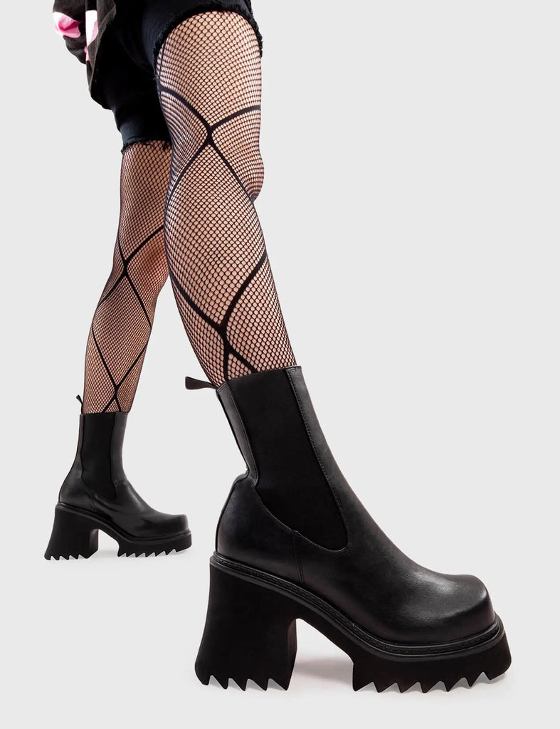 Anything But Basic Fireflies Chunky Platform Ankle Boots in Black faux leather. These platform boots feature an elegant, minimalist design, with an elastic gusset and a chunky sole, the perfect way to elevate any outfit. Made with eco-friendly materials and 100% cruelty-free, these platform boots are as ethical as they are cool. - Platform Height - Heel Height - Elastic gusset - Black Zip - Shark's teeth grip - Chunky Platform sole - 100% vegan SKU: LMF 2911 - BlackPU