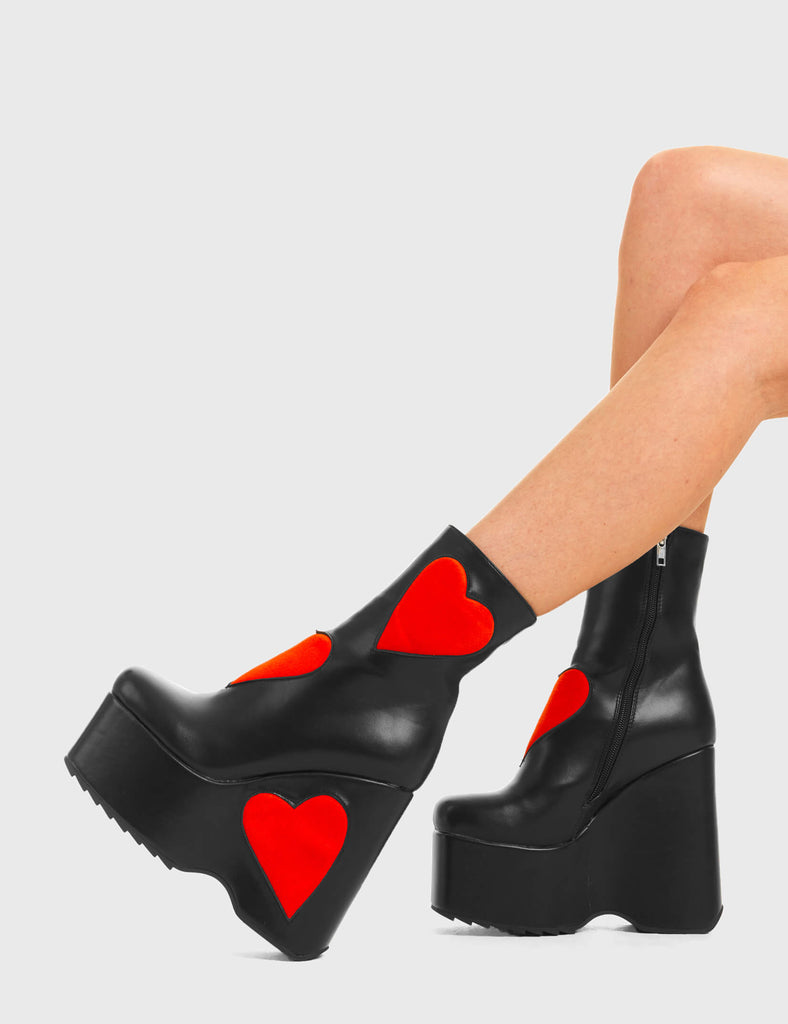 IT'S ALL ABOUT LOVE Full Time Lover Chunky Platform Ankle Boots in Black faux leather. These platform boots feature big red hearts with a platformed wedge. Made with eco-friendly materials and 100% cruelty-free, these platform boots are as ethical as they are chic. - Platform Height - Ankle length - Red hearts - Rounded toe - High Heel - 100% vegan SKU: LMF 3538 - BlackPU/RedHeart