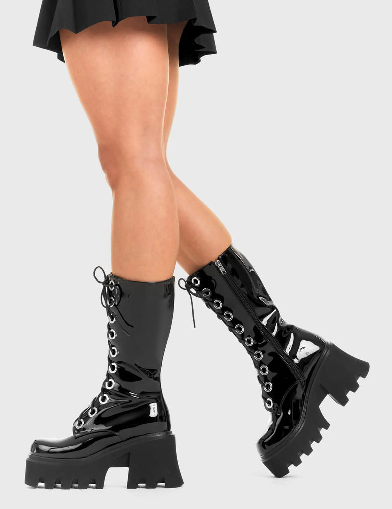 THESE BOOTS ARE MADE FOR WALKING Get Paid Chunky Platform Calf Boots in Black patent. These vegan western Boots feature a black lace up boot with silver round eyelets , very classy. Made with eco-friendly materials and 100% cruelty-free, these boots are as ethical as they are edgy! - Chunky Platform - Calf length - Lace up - Silver round eyelets - Rounded toe - 100% vegan SKU: LMF 3605 - BlackPAT