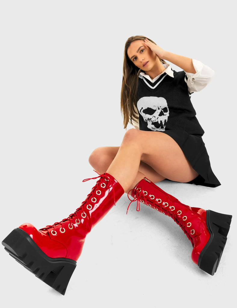 THESE BOOTS ARE MADE FOR WALKING Get Paid Chunky Platform Calf Boots in Red patent. These vegan western Boots feature a black lace up boot with silver round eyelets , very classy. Made with eco-friendly materials and 100% cruelty-free, these boots are as ethical as they are edgy! - Chunky Platform - Calf length - Lace up - Silver round eyelets - Rounded toe - 100% vegan SKU: LMF 3605 - RedPAT