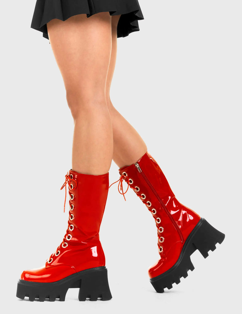 THESE BOOTS ARE MADE FOR WALKING Get Paid Chunky Platform Calf Boots in Red patent. These vegan western Boots feature a black lace up boot with silver round eyelets , very classy. Made with eco-friendly materials and 100% cruelty-free, these boots are as ethical as they are edgy! - Chunky Platform - Calf length - Lace up - Silver round eyelets - Rounded toe - 100% vegan SKU: LMF 3605 - RedPAT
