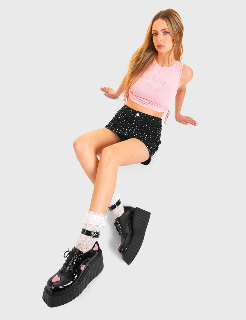 HIGH MOOD Good Day Chunky Platform Creeper Shoes in Black Patent. These vegan shoes feature pink hearts and a adjustable strap, very classy. Made with eco-friendly materials and 100% cruelty-free, these boots are as ethical as they are edgy! - Chunky Platform - Ankle length - Adjustable straps - Silver Buckle - Pink Heart feature - Rounded toe - 100% vegan SKU: LMF 3620 - BlackPAT/PinkHeart