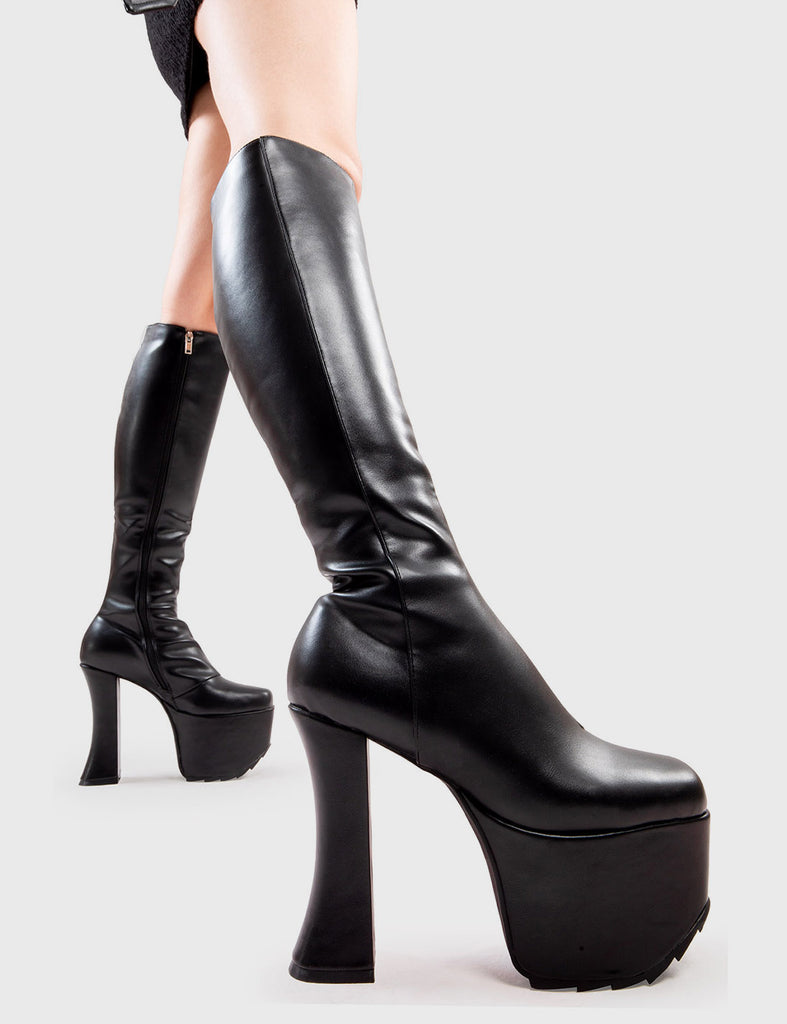 Making them Stare! Goodbye Platform Knee High Boots in Black faux leather. These platform boots feature a minimalist design, on our platform sole and curved heel. Made with eco-friendly materials and 100% cruelty-free, these platform boots are as ethical as they are Trendy. - Platform Height - Heel Height - Black zip - Curved Heel - Platform Sole - 100% vegan SKU: LMF 2995 - BlackPU