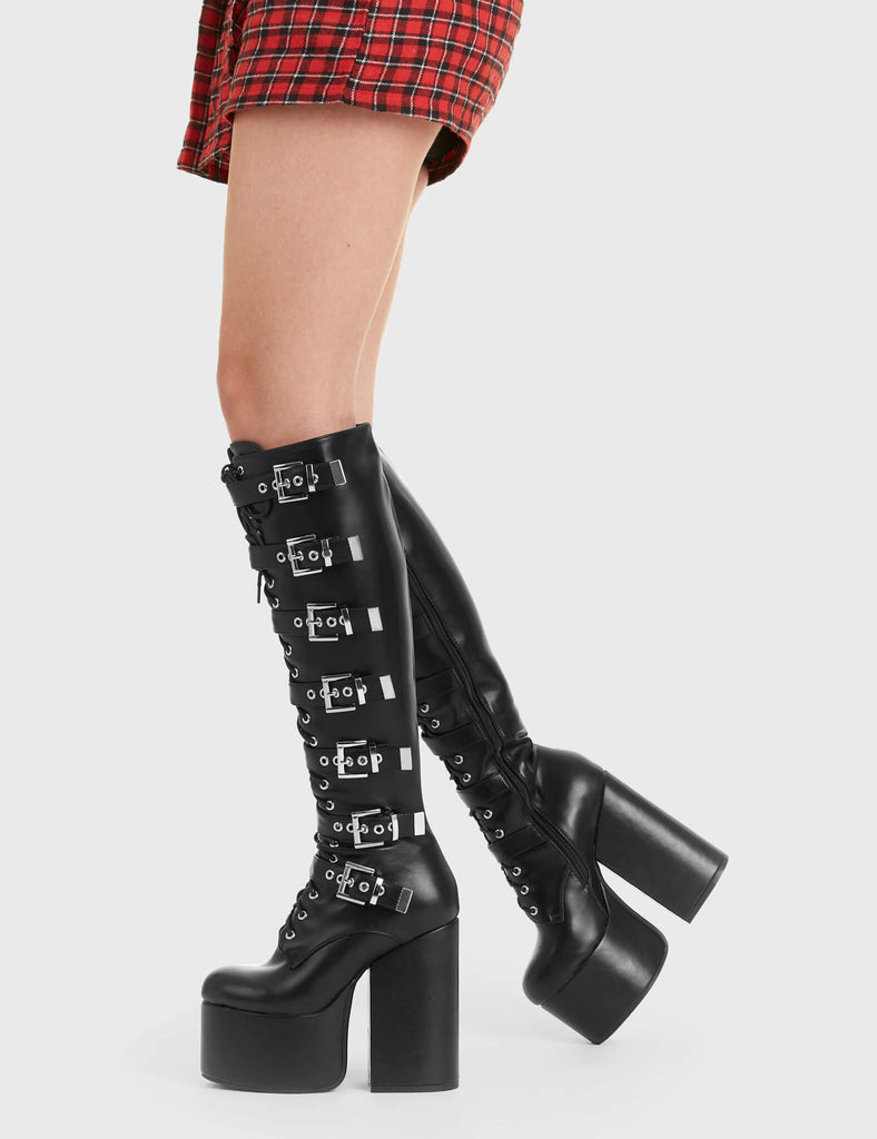 Not Your Basic Boots Gravity Platform Knee High Boots in Black faux leather. These platform boots feature a lace-up design, with silver square buckles, the perfect showstopper. Made with eco-friendly materials and 100% cruelty-free, these platform boots are as ethical as they are Edgy! - Platform Height - Heel Height - Lace-up - Silver square buckles - Black Zipper - Knee length - Platform sole - High Heel - 100% vegan SKU: LMF 2855 - BlackPU
