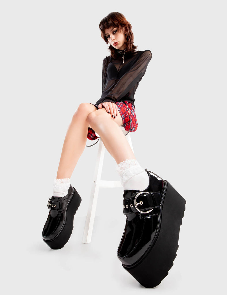Step Out in Fashion Grounded Chunky Platform Shoes in Black Patent. These flatform shoes feature a large strap with a large silver 'O' ring buckle. Made with eco-friendly materials and 100% cruelty-free, these platform boots are as ethical as they are Edgy - Platform Height - Large strap - Silver buckle and eyelets - Flatform Sole - Shark's Teeth Grip - 100% vegan SKU: LMF 3133 - BlackPAT