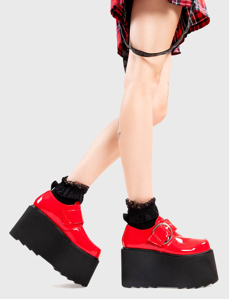 Step Out in Fashion Grounded Chunky Platform Shoes in Red Patent. These flatform shoes feature a large strap with a large silver 'O' ring buckle. Made with eco-friendly materials and 100% cruelty-free, these platform boots are as ethical as they are Edgy - Platform Height - Large strap - Silver buckle and eyelets - Flatform Sole - Shark's Teeth Grip - 100% vegan SKU: LMF 3133 - RedPAT