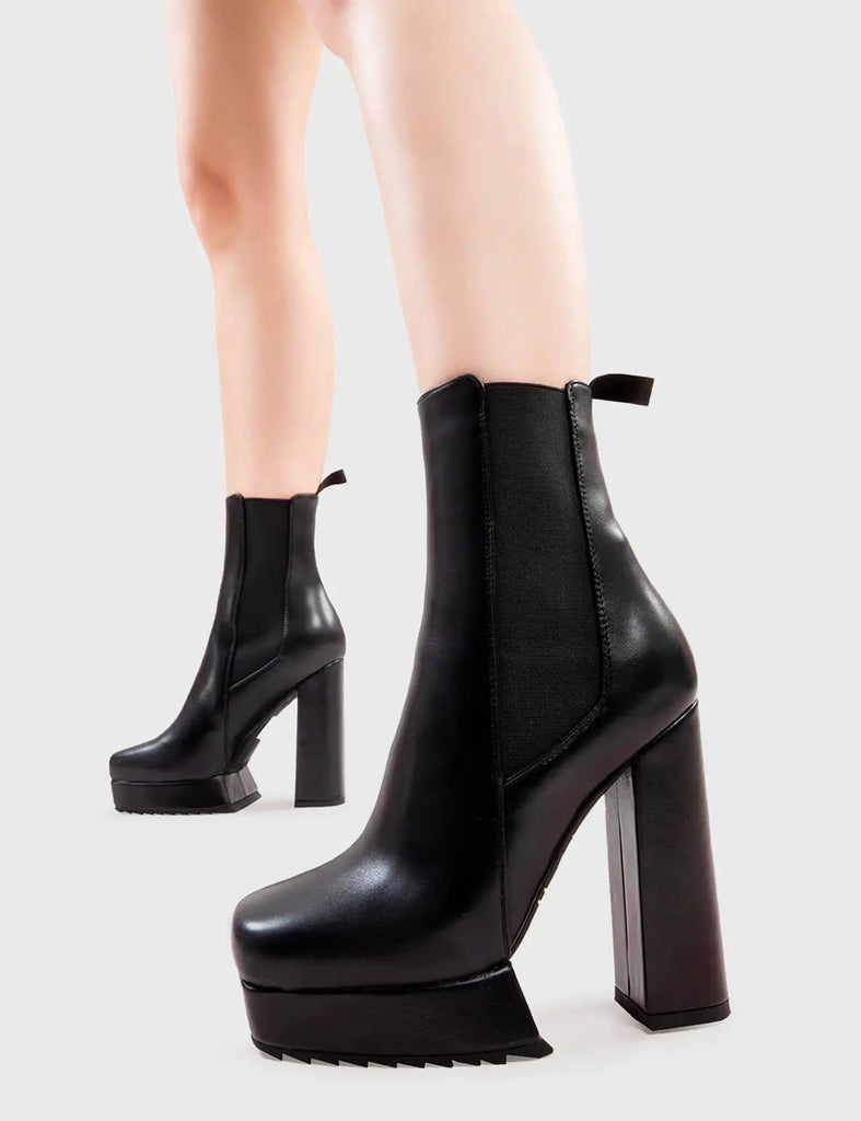 Better Than Basic Hackers Platform Ankle Boots in Black faux leather. These platform boots feature a minimalist design with a stretchy gusset and pull tag, the perfect boots with any outfit. Made with eco-friendly materials and 100% cruelty-free, these platform boots are as ethical as they are Iconic! - Platform Height - Heel Height - Gusset and Pull Tag - Ankle length - Shark's teeth grip - Platform sole - 100% vegan SKU: LMF 2835 - BlackPU