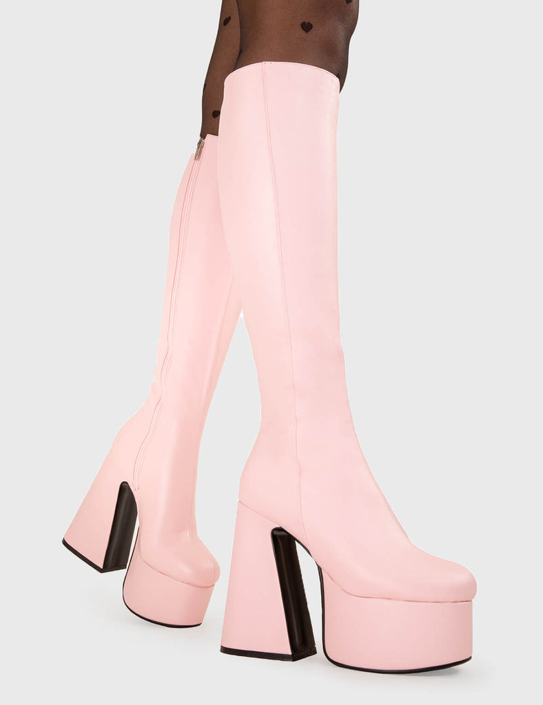NICE AND SMOOTH Hate You Platform Knee High Boots in Pink faux leather. These platform boots feature a minimalist look with a Flared heel, keeping it nice and classy. Made with eco-friendly materials and 100% cruelty-free, these platform boots are as ethical as they are chic. - Platform Height - Knee high - Flared heel - High Heel - 100% vegan SKU: LMF 3355 - PinkPU