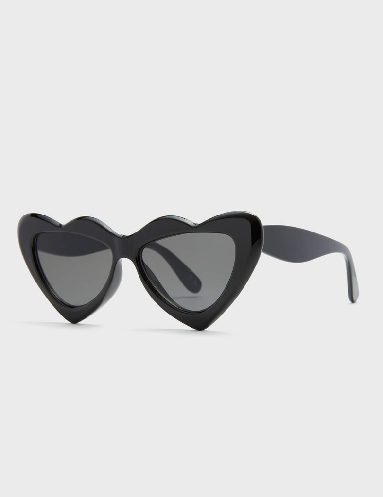 Heart Stopper Cateye Sunglasses in Black. These Cateye sunglasses feature a Heart inspired Black border and a Black tinted lens.&nbsp;