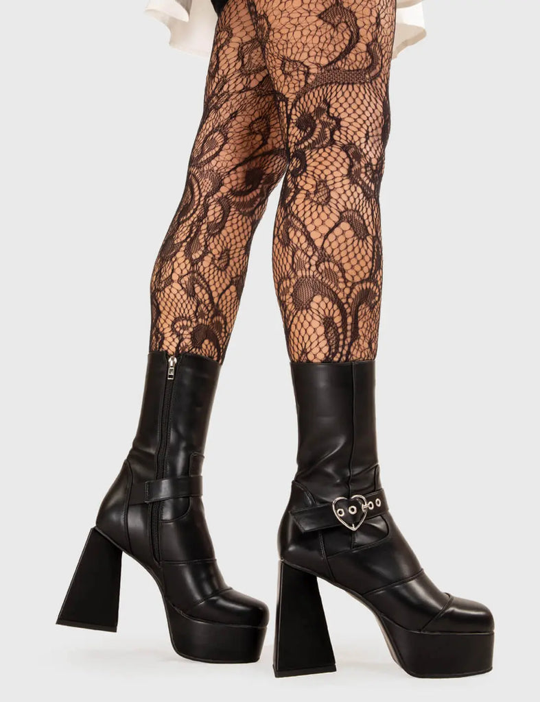 YOU TAKE MY BREATH AWAY Hotline Platform Ankle Boots in black faux leather. These platform boots feature a heart star buckle with an adjustable strap, keeping it nice and edgy. Made with eco-friendly materials and 100% cruelty-free, these platform boots are as ethical as they are chic. - Platform Height - Silver heart buckles - Calf length - Adjustable straps - Lace up - Triangle heel - High Heel - 100% vegan SKU: LMF 3335 - BlackPU