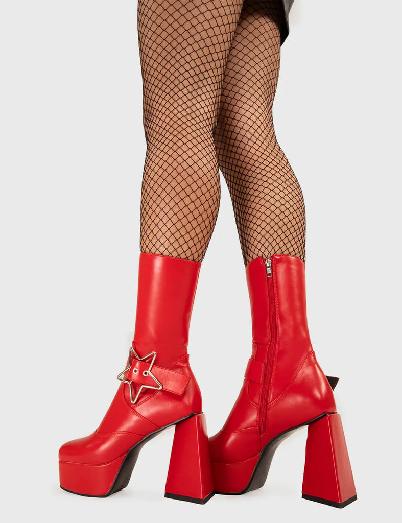 STAR IN THE SKY Hound Dog Platform Ankle Boots in Red faux leather. These platform boots feature a silver star buckle with an adjustable strap, keeping it nice and edgy. Made with eco-friendly materials and 100% cruelty-free, these platform boots are as ethical as they are chic. - Platform Height - Silver Star buckles - Calf length - Adjustable straps - Triangle heel - High Heel - 100% vegan SKU: LMF 3336 - RedPU