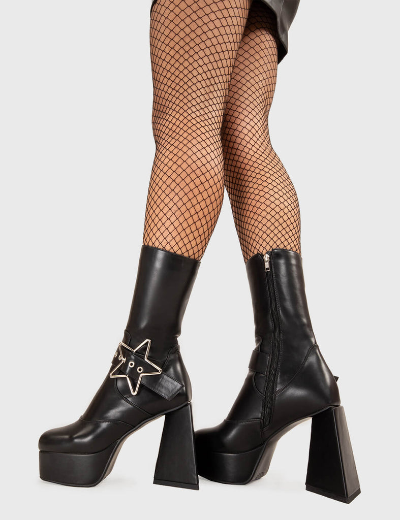 STAR IN THE SKY Hound Dog Platform Ankle Boots in Black faux leather. These platform boots feature a sliver star buckle with an adjustable strap, keeping it nice and edgy. Made with eco-friendly materials and 100% cruelty-free, these platform boots are as ethical as they are chic. - Platform Height - Silver Star buckles - Calf length - Adjustable straps - Triangle heel - High Heel - 100% vegan SKU: LMF 3336 - BlackPU