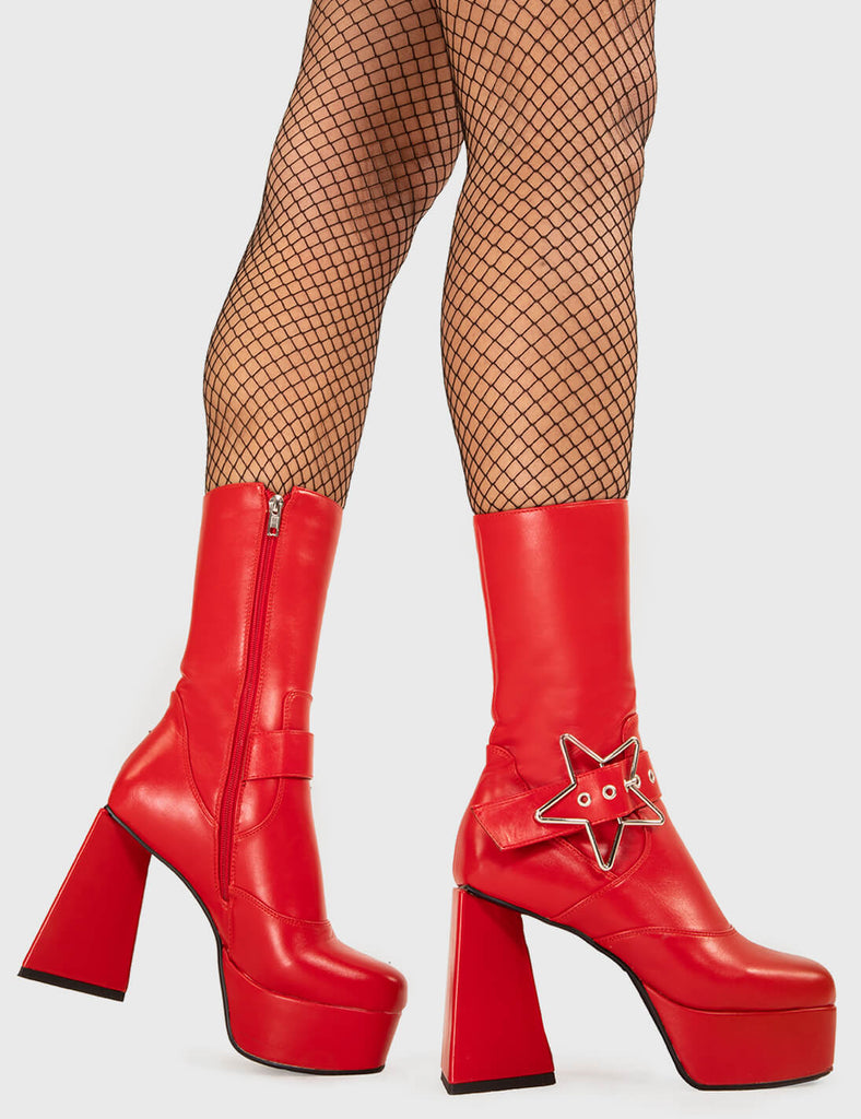 STAR IN THE SKY Hound Dog Platform Ankle Boots in Red faux leather. These platform boots feature a silver star buckle with an adjustable strap, keeping it nice and edgy. Made with eco-friendly materials and 100% cruelty-free, these platform boots are as ethical as they are chic. - Platform Height - Silver Star buckles - Calf length - Adjustable straps - Triangle heel - High Heel - 100% vegan SKU: LMF 3336 - RedPU