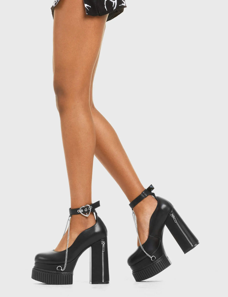 CHAINED UP I Wanna Be Creeper Platform Heels in Black faux leather. These vegan western Boots feature a sliver heart buckle and chain detailing, very edgy. Made with eco-friendly materials and 100% cruelty-free, these boots are as ethical as they are trendy! - Heel Height - Ankle length - Adjustable straps - Silver heart buckle - Sliver zip on heel - Hanging chains - Rubber grip sole - Rounded toe - 100% vegan SKU: LMF 3957 - BlackPU