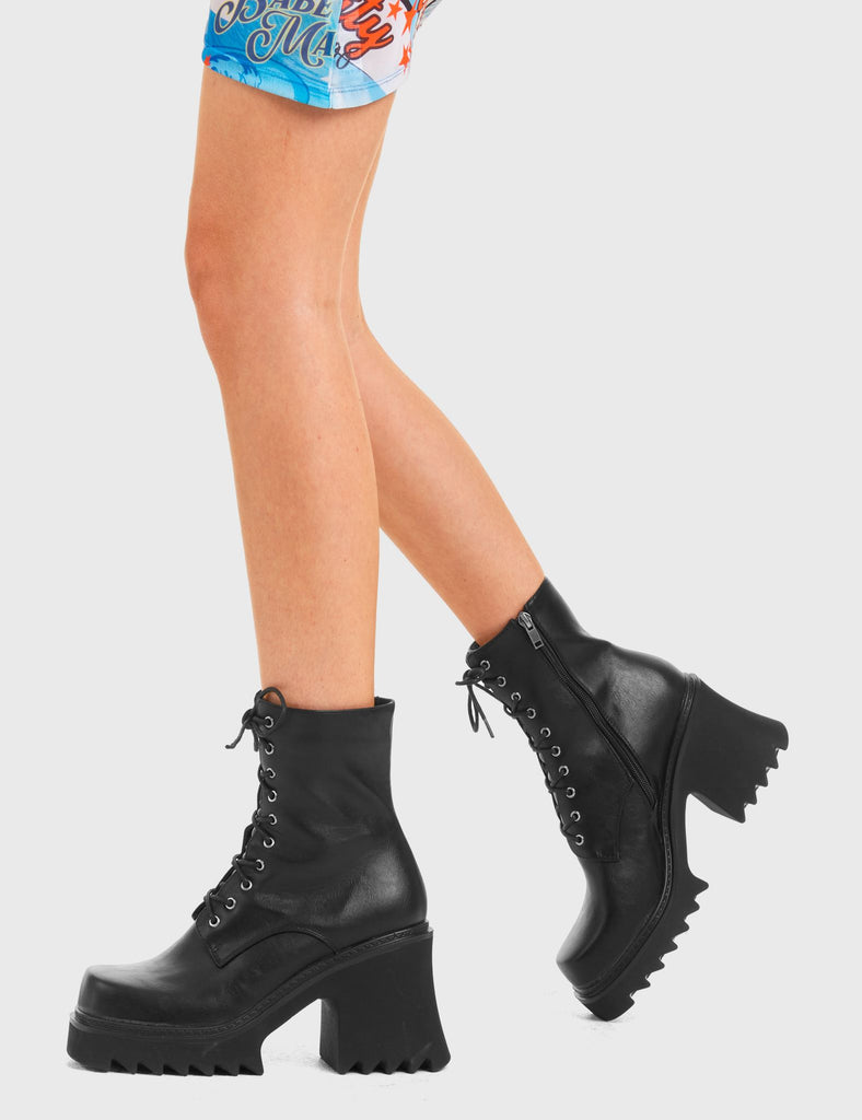 ON A HIGH In Opposition Chunky Platform Ankle Boots in Black faux leather. These vegan western Boots feature black laces and a shark teeth grip sole, very chic. Made with eco-friendly materials and 100% cruelty-free, these boots are as ethical as they are edgy! - Chunky Platform - Calf length - Shark teeth grip - Black laces - Rounded toe - 100% vegan SKU: LMF 3729 - BlackPU