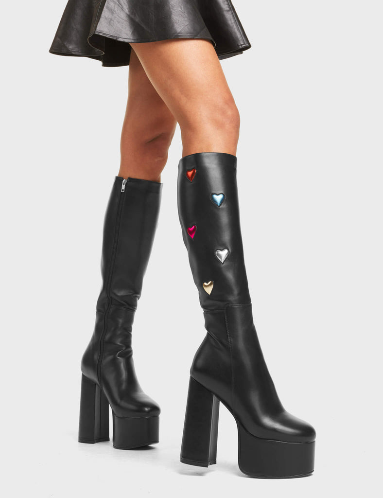 Intimate Platform Knee High Boots in Black. These boots feature multi-coloured metallic hearts on a minimalist black design with a high platform sole. Made with eco-friendly materials and 100% cruelty-free!