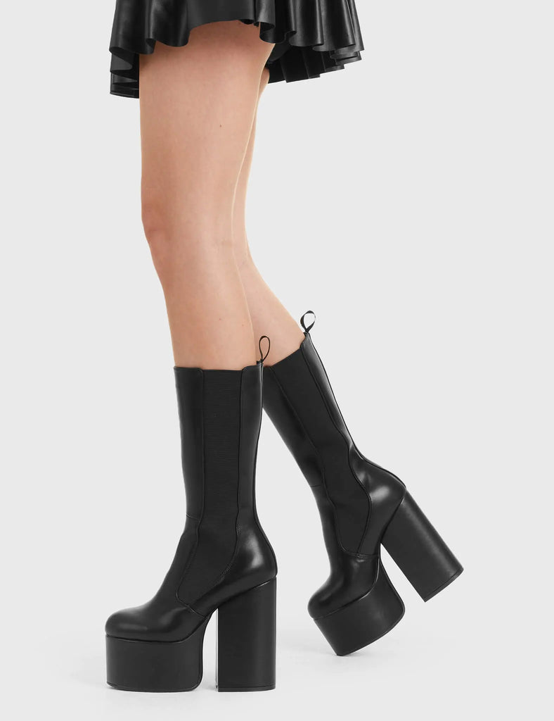 Not Your Basic Boots Intrusion Platform Calf Boots in Black faux leather. These platform boots feature a minimalist design, with a stretchy gusset and a pull tag, perfect with any outfit. Made with eco-friendly materials and 100% cruelty-free, these platform boots are as ethical as they are Perfect! - Platform Height - Heel Height - gusset and pull tag - calf length - Platform sole - High Heel - 100% vegan SKU: LMF 2850 - BlackPU