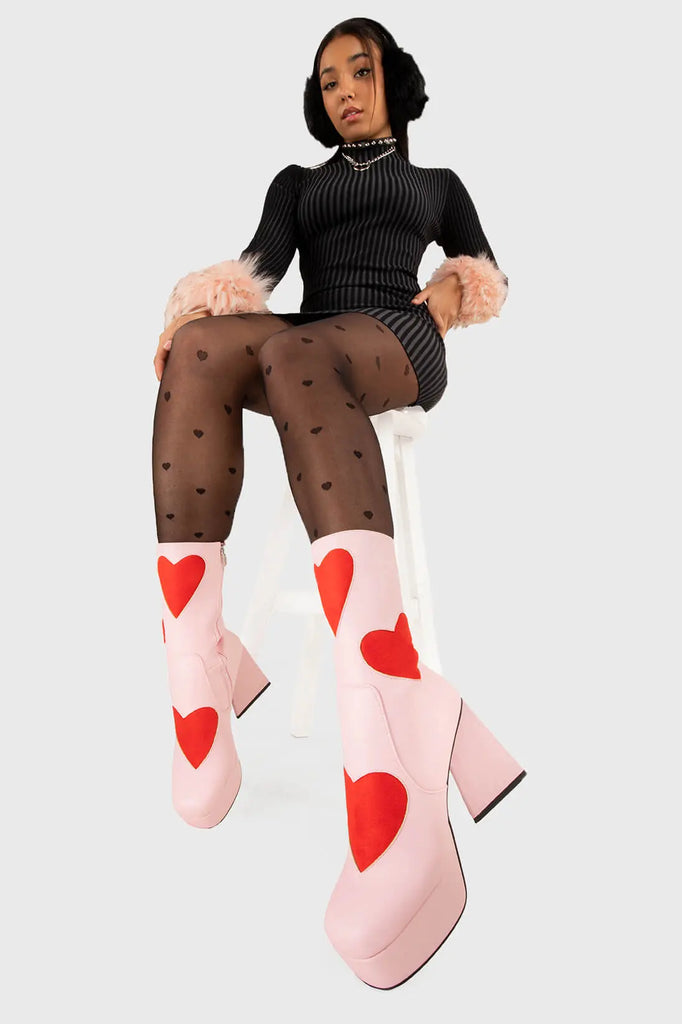 LOVEY DOVEY Letter To My Lover Platform Ankle Boots in Pink faux leather. These platform boots feature a pink boot with big red heart all over. Made with eco-friendly materials and 100% cruelty-free, these platform boots are as ethical as they are chic. - Platform Height - Big red hearts - Calf length - Triangle heel - High Heel - 100% vegan SKU: LMF 3337 - PinkPU/RedHeart