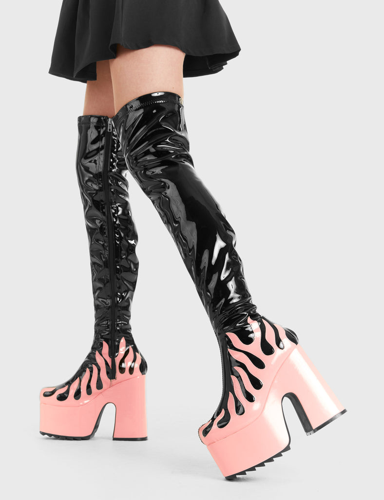 Bring The Heat Light Up Platform Thigh High Boots in Black Patent. These platform boots feature a Pink Patent flame as well as a Pink Patent Platform, elevate your fashion game. Made with eco-friendly materials and 100% cruelty-free, these platform boots are as ethical as they are Hot. - Platform Height - Heel Height - Black Zip - Pink Patent Flame - Chunky Platform sole - Shark's teeth grip - 100% vegan SKU: LMF 2937 Black Patent/ Pink Flame