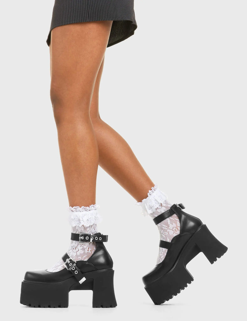 CUTIE PIE Look Away Chunky Platform Shoes in Black faux leather. These vegan western Boots feature a minimalist design with two adjustable straps, very chic. Made with eco-friendly materials and 100% cruelty-free, these boots are as ethical as they are cute! - Platformed - Ankle length - Two adjustable straps - Silver square buckles - Chunky platform sole - Rounded toe - 100% vegan SKU: LMF 3928 - BlackPU