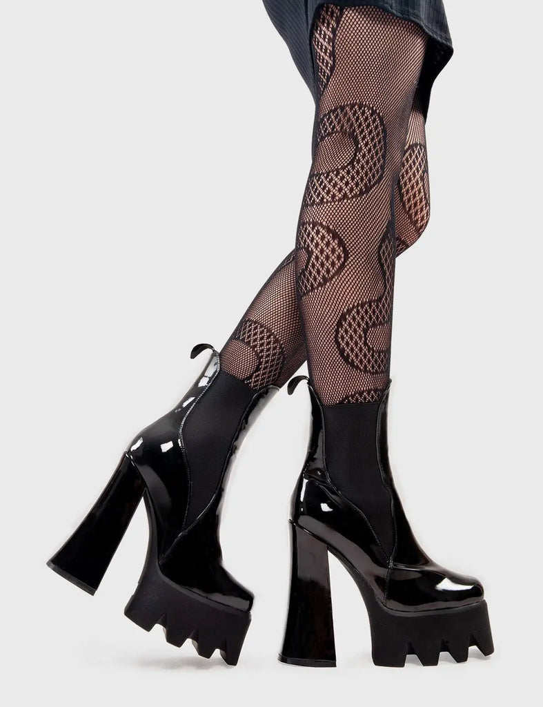 Trend Setter Lumiel Platform Ankle Boots in Black Patent. These platform boots feature a minimalist design with a gusset and pull tag. They are the perfect way to elevate any look. Made with eco-friendly materials and 100% cruelty-free, these platform boots are as ethical as they are Trendy. - Platform Height - Heel Height - Gusset and pull tag - Black Zip - High Heel - Platform Sole - 100% vegan SKU: LMF 2973 - BlackPAT