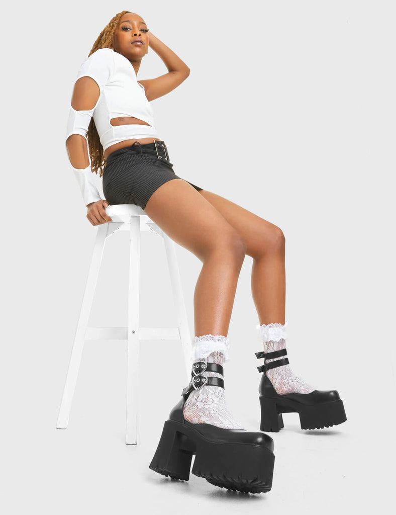 LOVED UP Mistake Chunky Platform Shoes in Black faux leather. These vegan western Boots feature a minimalist design with two adjustable straps, very cute. Made with eco-friendly materials and 100% cruelty-free, these boots are as ethical as they are chic! - Platformed - Ankle length - Two adjustable straps - Silver heart buckles - Chunky platform sole - Rounded toe - 100% vegan SKU: LMF 3927 - BlackPU