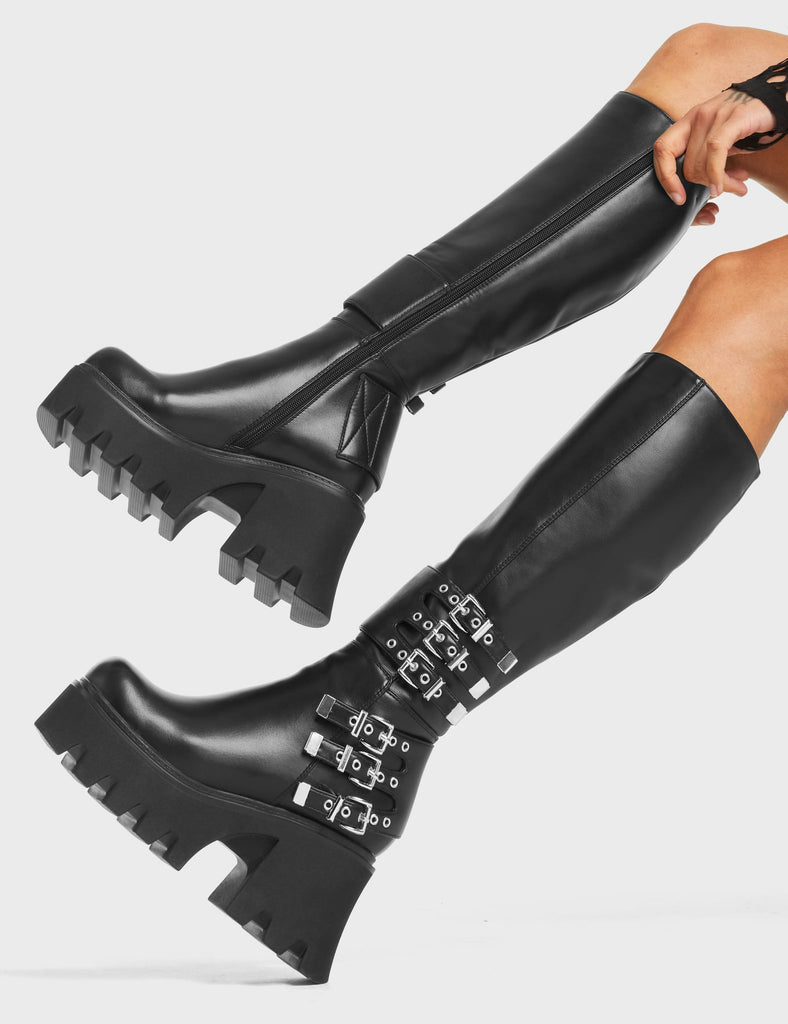 My Prince Chunky Platform Knee High Boots in Black faux leather. These boots feature six adjustable straps with silver eyelets and square-shaped buckles. Made with eco-friendly materials and 100% cruelty-free!