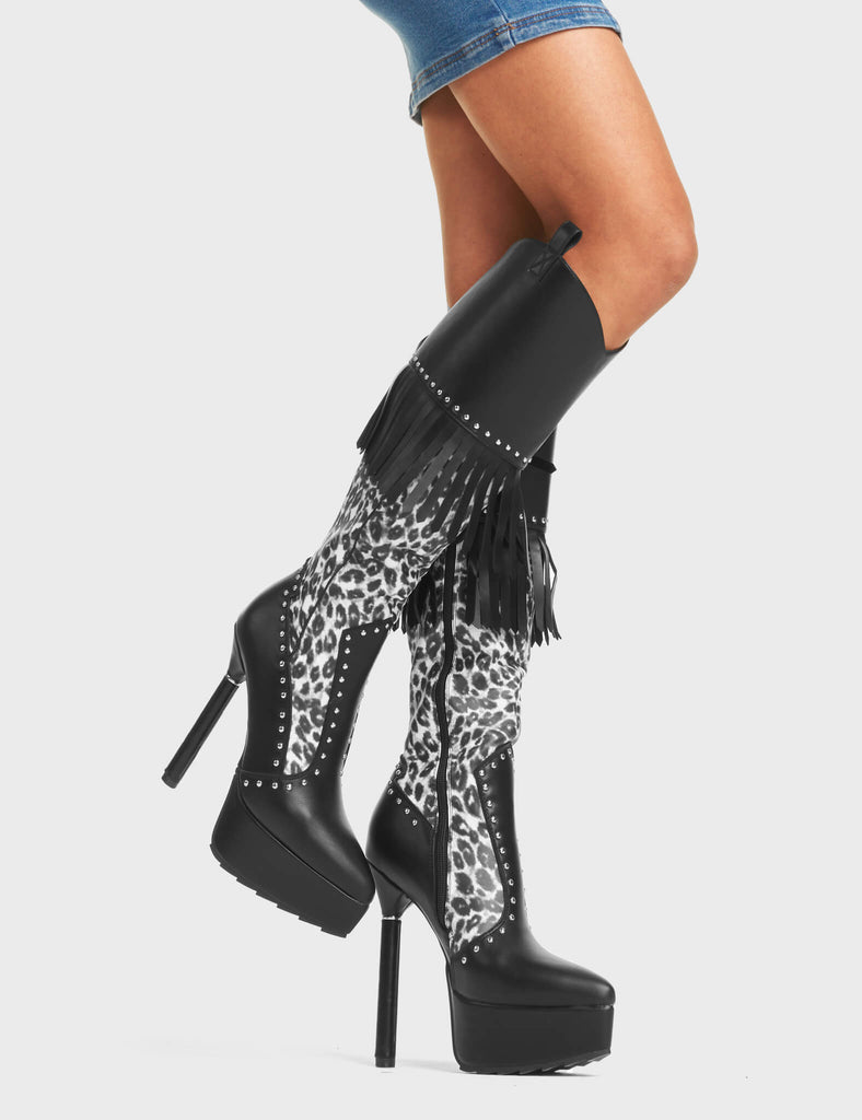 My Priority Western Platform Calf Boots. These western platform boots feature a leopard print upper with silver studs, black tassels and a signature thin silver ring platform heel. Made with eco-friendly materials and 100% cruelty-free.