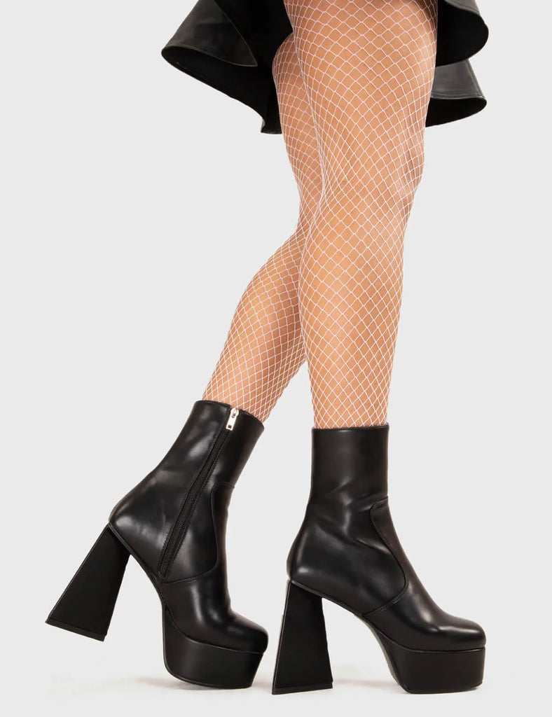 KEEPING IT SLEEK Never Simple Platform Ankle Boots in Black faux leather. These platform boots feature a minimalist look with a triangle heel, keeping it nice and classy. Made with eco-friendly materials and 100% cruelty-free, these platform boots are as ethical as they are chic. - Platform Height - Ankle length - Triangle heel - High Heel - 100% vegan SKU: LMF 3329 - BlackPU