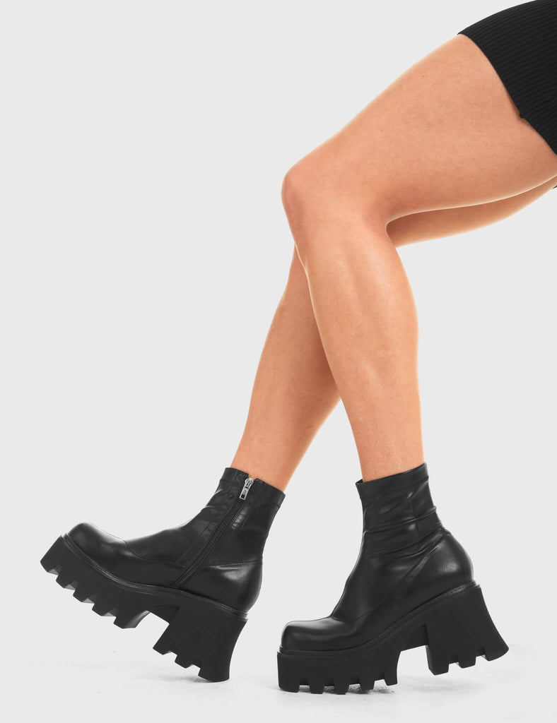 UPGRADE YOUR STYLE Notorious Chunky Platform Ankle Boots in Black fitted faux leather. These vegan western Boots feature a minimalist look with chunky soles, very classy. Made with eco-friendly materials and 100% cruelty-free, these boots are as ethical as they are edgy! - Chunky Platform - Ankle length - Rounded toe - 100% vegan SKU: LMF 3601 - LMF 3601 - BlackStretchPU