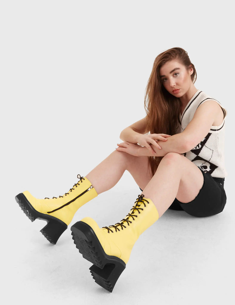 LACED UP On A Buzz Chunky Platform Ankle Boots in yellow faux leather. These vegan western Boots feature black laces and a shark teeth grip sole, very chic. Made with eco-friendly materials and 100% cruelty-free, these boots are as ethical as they are edgy! - Chunky Platform - Calf length - Shark teeth grip - Black laces - Rounded toe - 100% vegan SKU: LMF 3730 - LemonPU