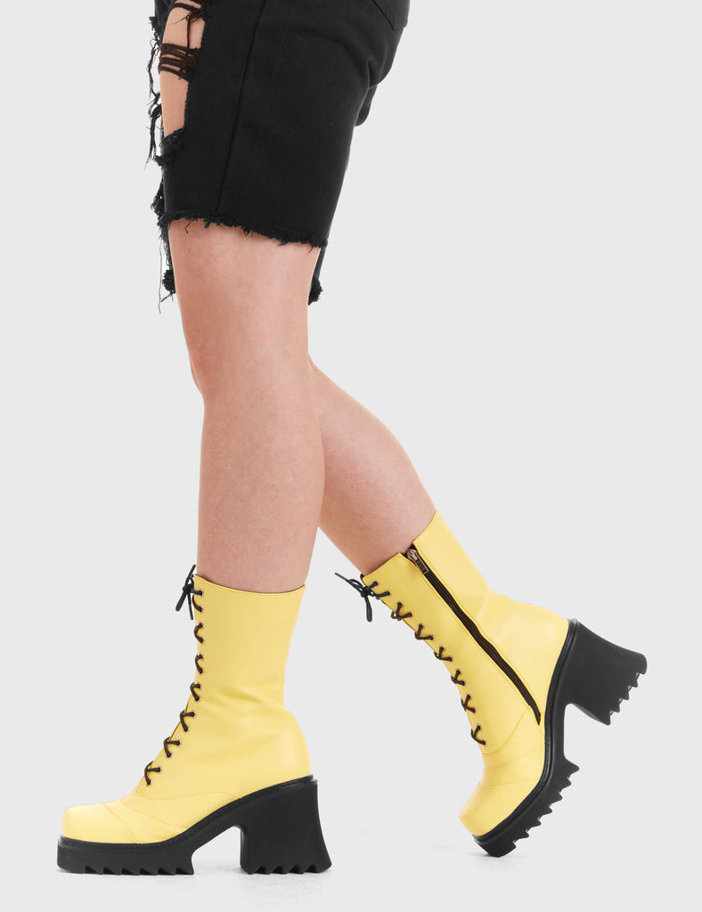LACED UP On A Buzz Chunky Platform Ankle Boots in yellow faux leather. These vegan western Boots feature black laces and a shark teeth grip sole, very chic. Made with eco-friendly materials and 100% cruelty-free, these boots are as ethical as they are edgy! - Chunky Platform - Calf length - Shark teeth grip - Black laces - Rounded toe - 100% vegan SKU: LMF 3730 - LemonPU