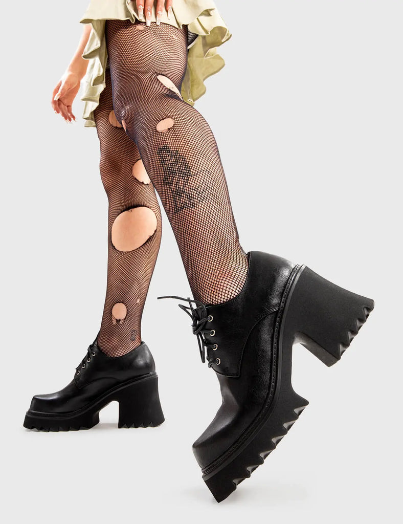 Too Kool For Skool Passing By Chunky Shoes in Black faux leather. These shoes feature an elegant, minimalist design, the perfect way to level-up your looks. Made with eco-friendly materials and 100% cruelty-free, these shoes are as ethical as they are trendy. - Platform Height - Heel Height - lace-up with silver eyelets - Shark's teeth grip - Chunky Platform sole - 100% vegan SKU: LMF 2909 - BlackPU